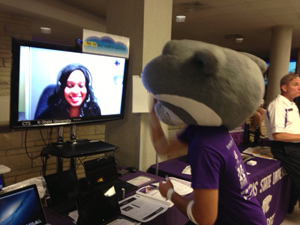 An IT Help Desk consultant videoconferences with Willie the Wildcat during 2013 Orientation and Enrollment