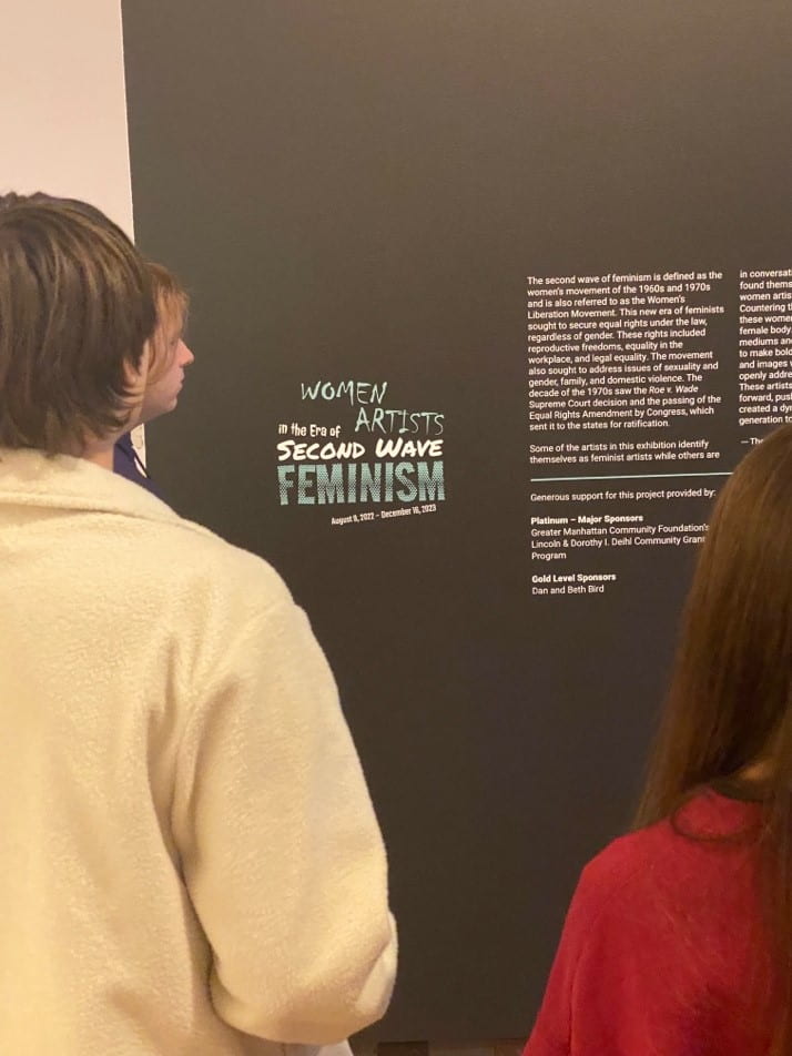 Students exploring the exhibition "Women Artists in the Era of Second Wave Feminism" at the Beach Museum of Art