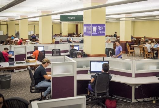 Dozens of students on the second floor of Hale Library study and use the computers and printers. 