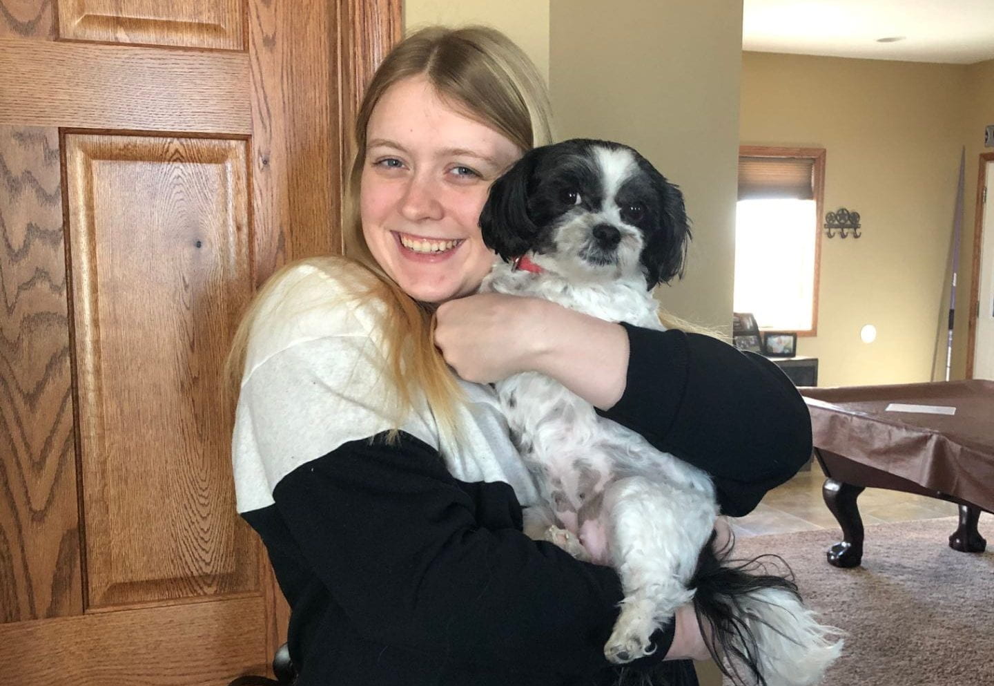 A picture of McKenna holding her dog, Molly.