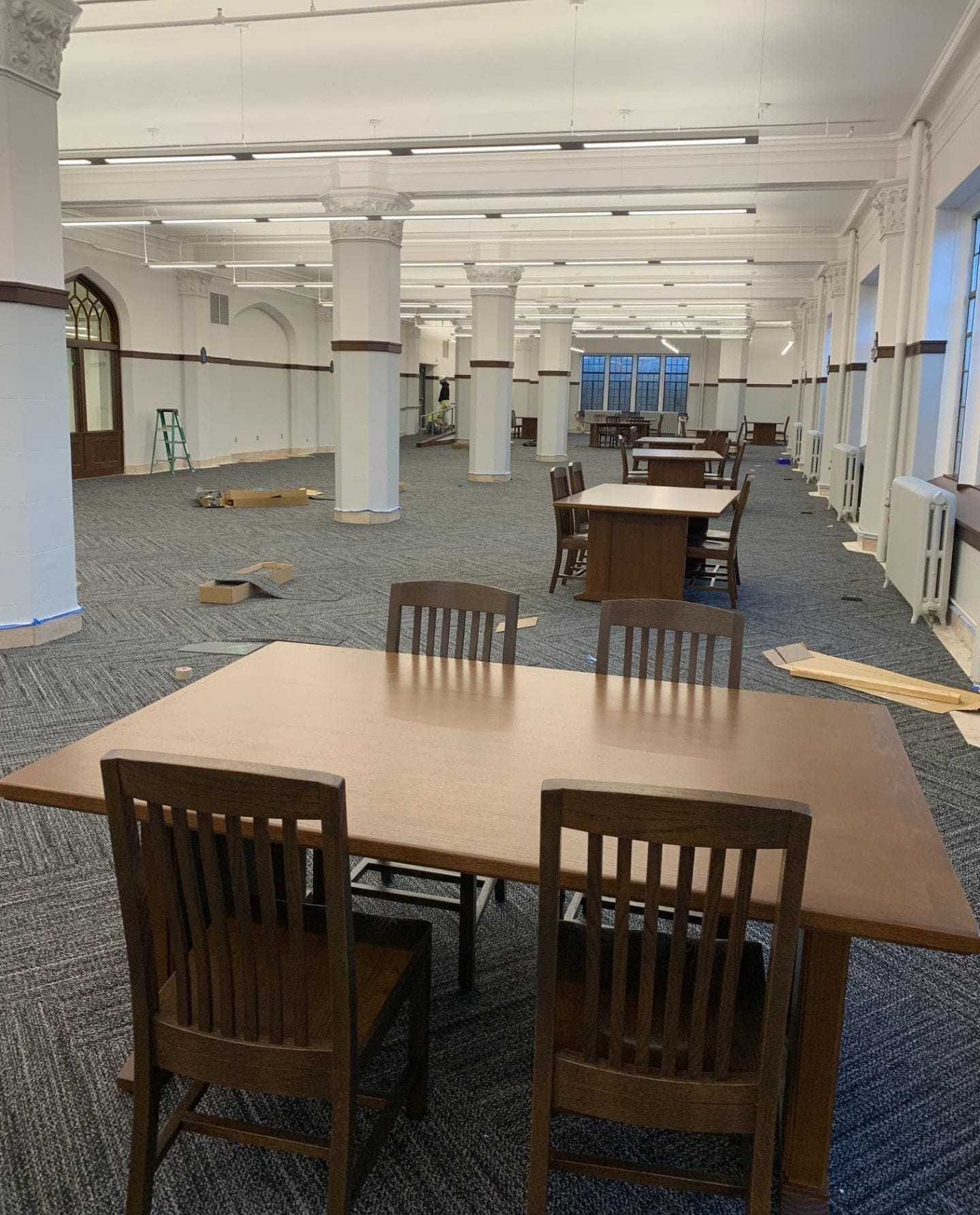 A few tables and chairs sit in an empty reading room.