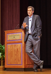 David Pogue, keynote speaker, casually leaning on the podium at Union Forum Hall (photo by Eric Dover)