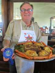 Royce Gilbert holds his winning meatloaf entry and the 1st place ribbon