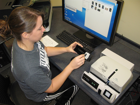 Student using the slide scanner in the Media Development Center, 213 Hale Library