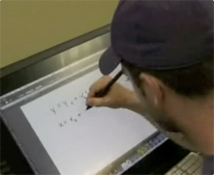 Photo of student writing an equation on the Wacom interactive display screen
