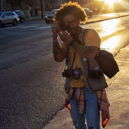 Man taking photo on city street