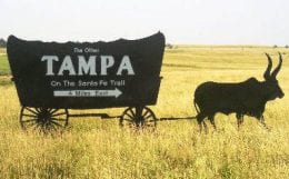 Steel highway sign, Tampa, Kansas, ox pulling covered wagon