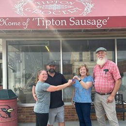Four people standing in front of Tipton Grocery