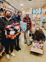photo: masked students donating supplies in a store